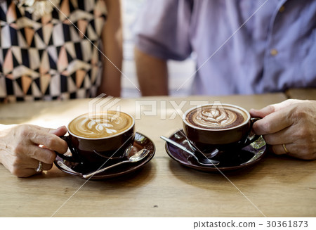 Mature couple drinking coffee together Mature couple drinking coffee together 30361873
