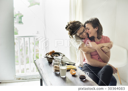 Lesbian Couple Together Indoors Concept Lesbian Couple Together Indoors Concept 30364083