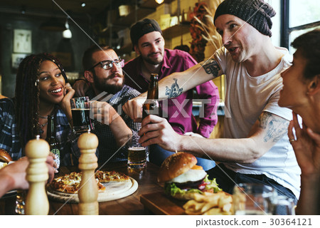 A group of friends at a party talking A group of friends at a party talking 30364121