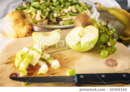 Ingredients for fruit salad. Cutting apple Ingredients for fruit salad. Cutting apple 30369168