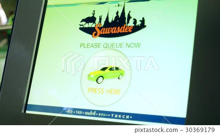 Traveler getting in to a taxi in airport zone 30369179