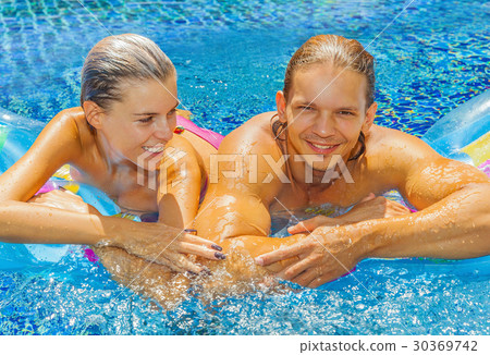 Couple in the pool 30369742