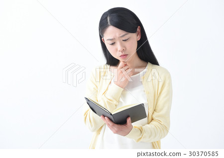A young woman thinking while watching your trouble note 30370585