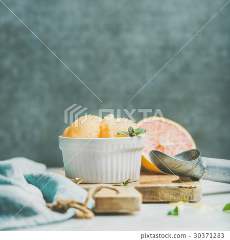 Pink grapefruit sorbet with mint in bowl on wooden 30371283