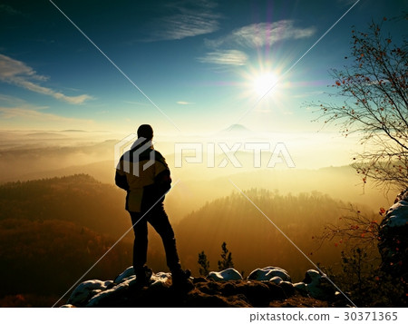 Tourist standing on rocky view point and watch Tourist standing on rocky view point and watch 30371365