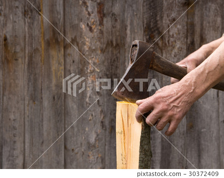 The old axe in the hands of an elderly person  30372409