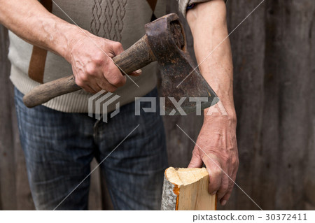 Worker, an elderly man with an old axe Worker, an elderly man with an old axe 30372411