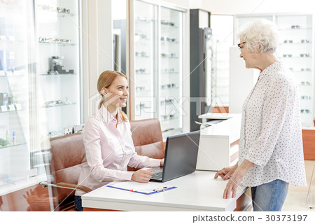 Affable glance of female shop advisor Affable glance of female shop advisor 30373197