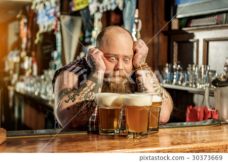 Wonder bearded male watching at beer 30373669