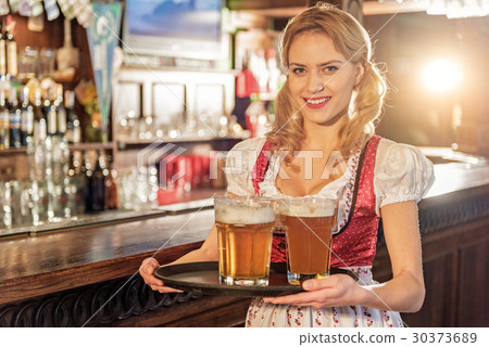 Cheerful woman holding tray with beer glasses 30373689