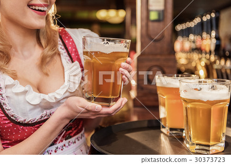 Outgoing woman arm keeping glass of beer Outgoing woman arm keeping glass of beer 30373723