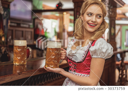 Outgoing woman serving glasses of beer 30373759
