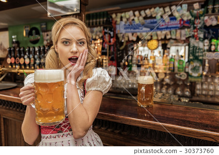 图库照片: dazing female holding glass of beer