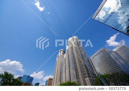 Skyscraper and sunlight shining through the clouds and blue sky Shinjuku sub-central Tokyo Metropolitan Government Office 30373778