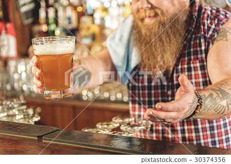 Man hand holding out drinks in pub Man hand holding out drinks in pub 30374356