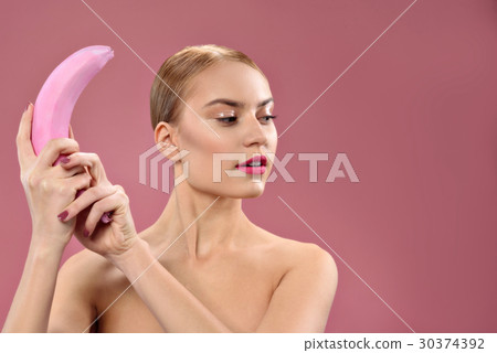 Young pretty woman making fun with banana 30374392