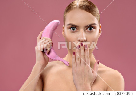 Attractive woman holding banana Attractive woman holding banana 30374396