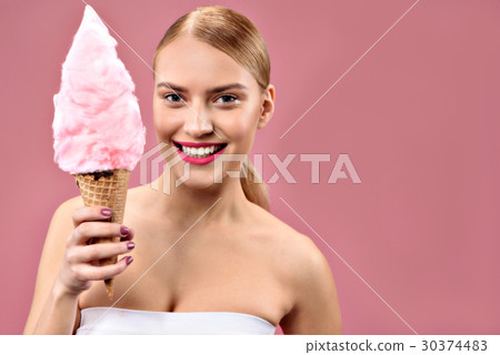 Joyful girl posing with cotton candy Joyful girl posing with cotton candy 30374483