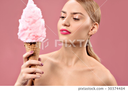 Happy pretty young woman holding cotton candy 30374484