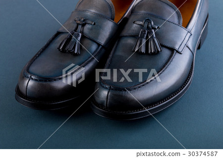 Blue loafer shoes on blue background. One pair. 30374587