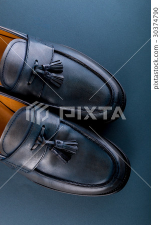 Blue loafer shoes on blue background. One pair 30374790