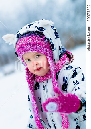 Child in snowy day. Baby girl in white Child in snowy day. Baby girl in white 30375832