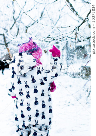 Child in snowy day. Baby girl in white Child in snowy day. Baby girl in white 30375834
