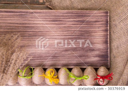 Little girl in green dress sitting on the waterm 30376919
