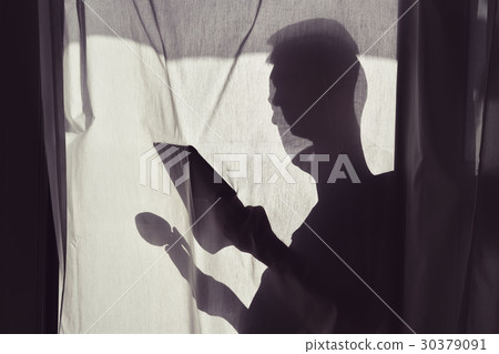 silhouette of man with caup and tablet 30379091