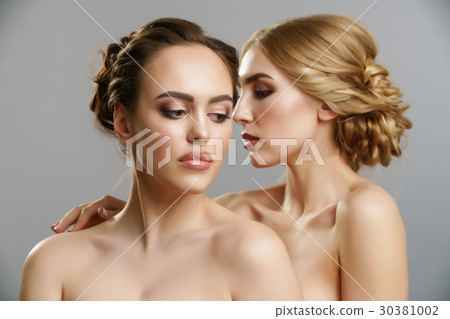 Two pretty girls posing naked in studio 30381002