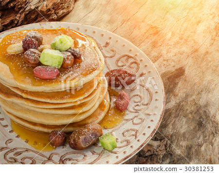 Stack of hot pancakes with nuts, dried fruits Stack of hot pancakes with nuts, dried fruits 30381253