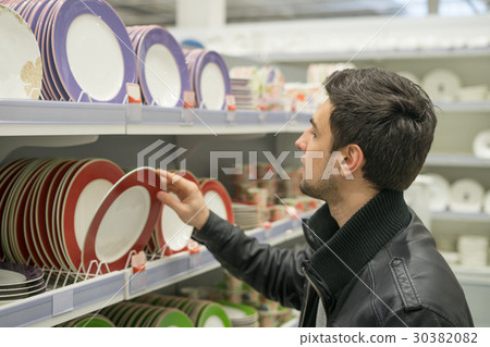 male customer choosing crockery plates male customer choosing crockery plates 30382082