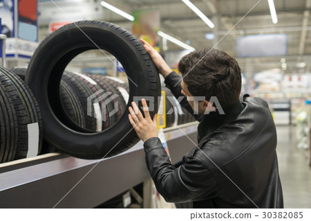 male customer choosing new tires male customer choosing new tires 30382085