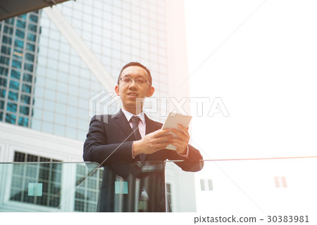 asian man using tablet outdoor 30383981