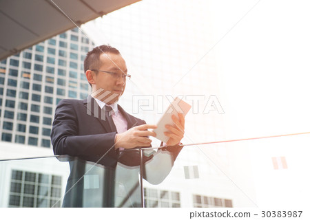 asian man using tablet outdoor 30383987