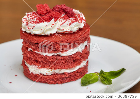Round red velvet cake with cream on white plate Round red velvet cake with cream on white plate 30387759