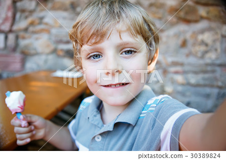 Kid boy taking selfie with mobile phone 30389824