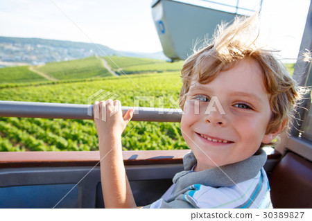 Smiling happy blond littlekid boy in cable 30389827