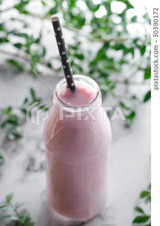 Close-up of bottle with a pink fresh berry 30390172