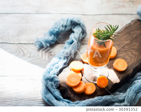 Orange carrot juice on wooden board Orange carrot juice on wooden board 30391352