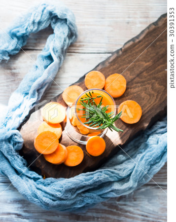 Orange carrot juice on wooden board Orange carrot juice on wooden board 30391353