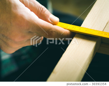 Man crafting wooden object with hands.  30391354