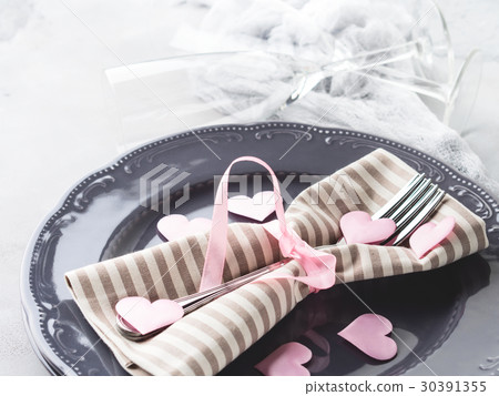 Romantic dinner date plates hearts glasses on gray 30391355