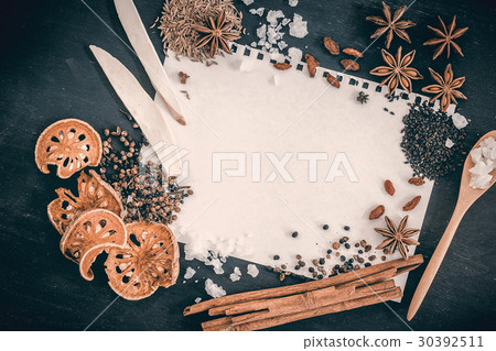 recipe book with fresh herbs and spices  30392511