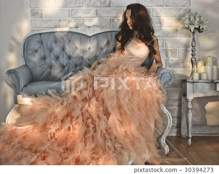 Beautiful lady in gorgeous couture dress on sofa Beautiful lady in gorgeous couture dress on sofa 30394273