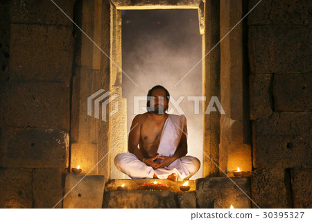 Priest or Yogi are sitting meditating in Ancient 30395327