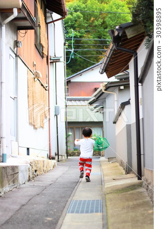 A boy walking in an alley 30398895