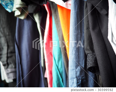 old cloth clothing hanger row close-up 30399592