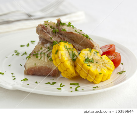 Gourmet pork ribs served with parsley and corn 30399644