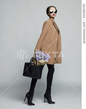 Young stylish woman in beige coat 30399795